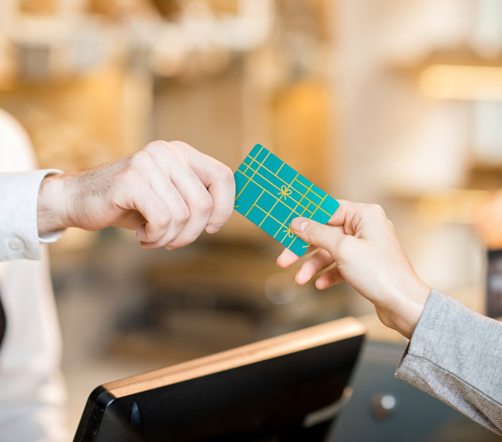 Image of someone paying with a gift card