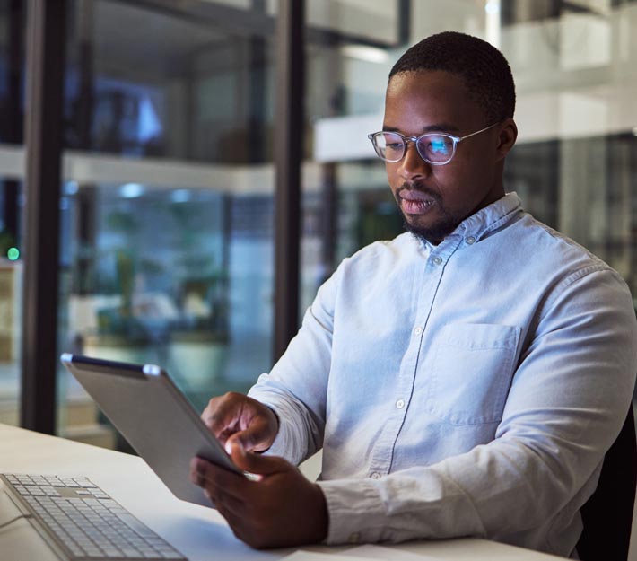 Man works at a cyber security job at night