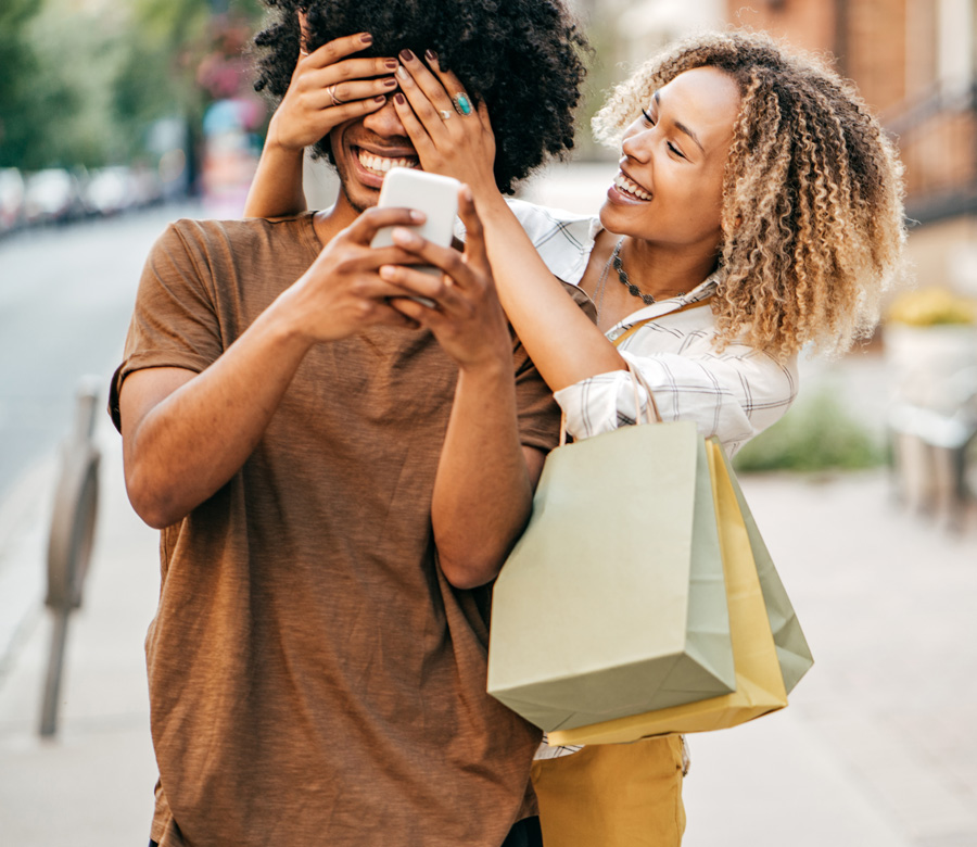 Man and woman smile together as they're shopping