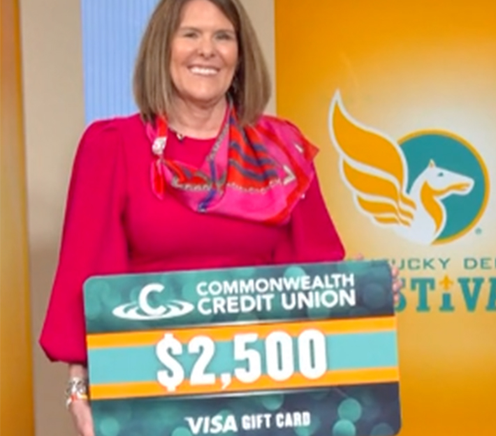 Picture of Karen Harbin holding a poster that says $2,500 Visa Gift Card.