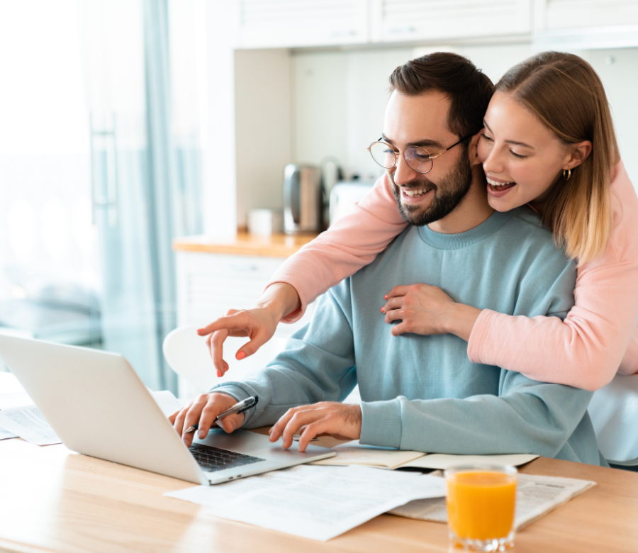 couple smiling at computer