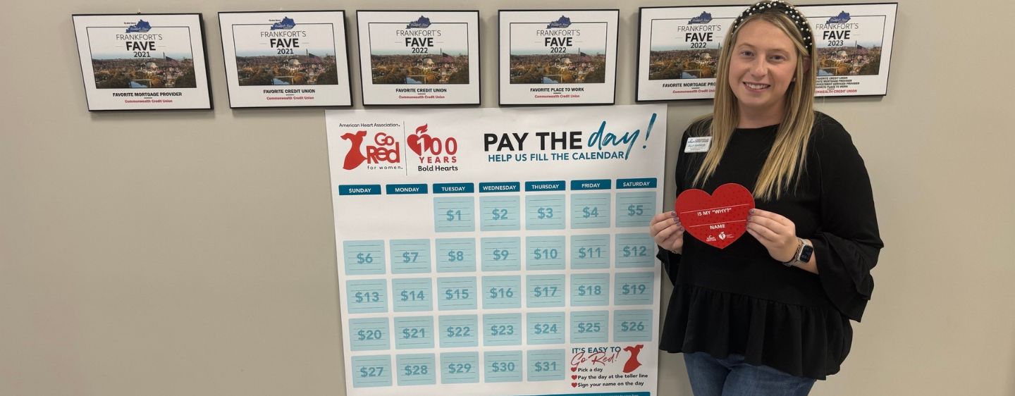 CCU team Member Ally Harrod posed in front of 31 Days to Go Red signage.