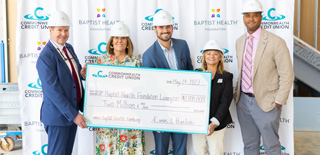 Image of CCU leadership holding a large donation check