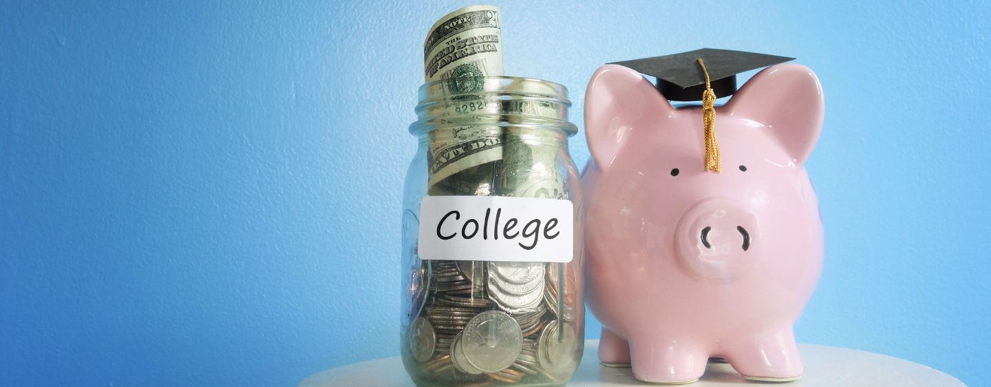 Piggy bank wearing grad cap.