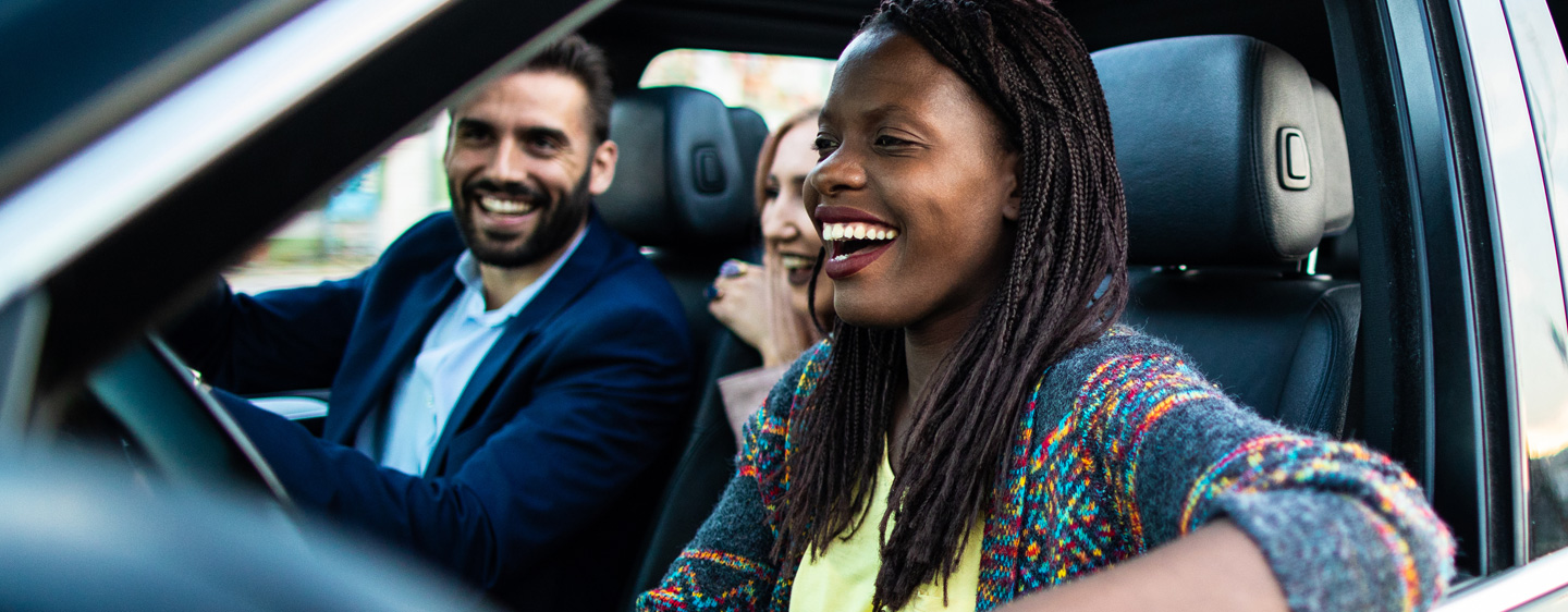 Smiling people in a car.