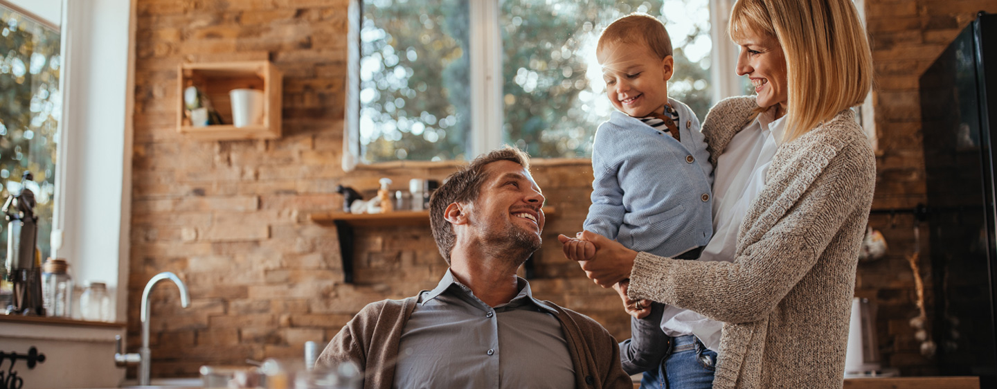 Header graphic for Skip A Payment program, a family smiles together in their kitchen