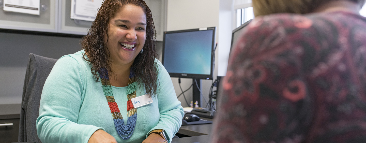 Photo of team member Lucia helping a member