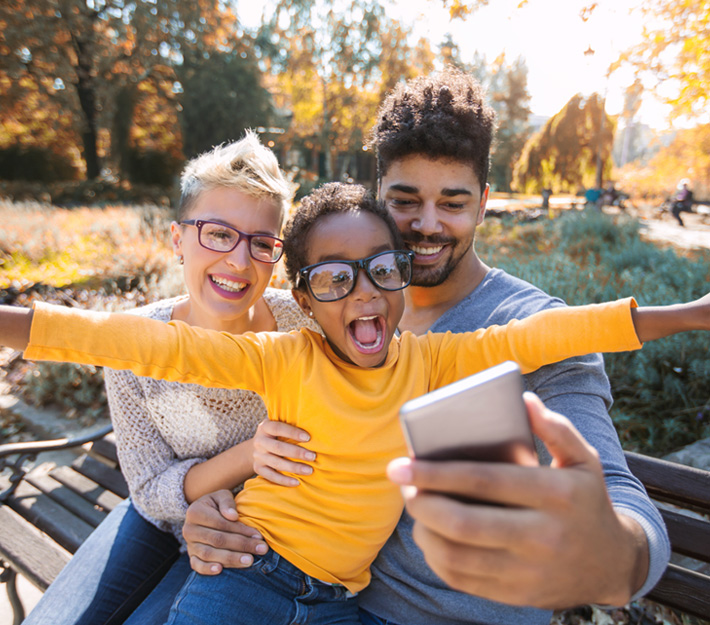 A family of three taking a selfy.