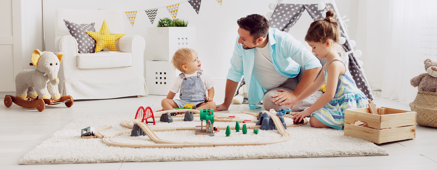 Father and two children play together 