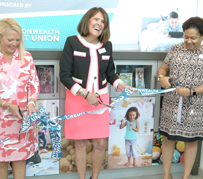 Karen Harbin cutting ribbon at Make-A-Wish Toy Closet celebration.