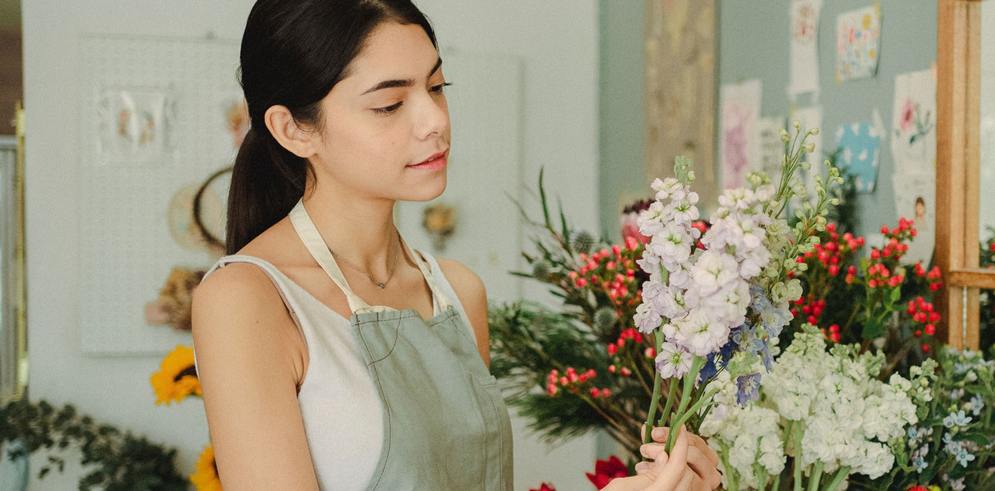 Woman arranging flowers at her flower shop.