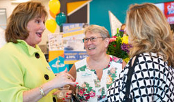 Employees chat with guests at a branch.