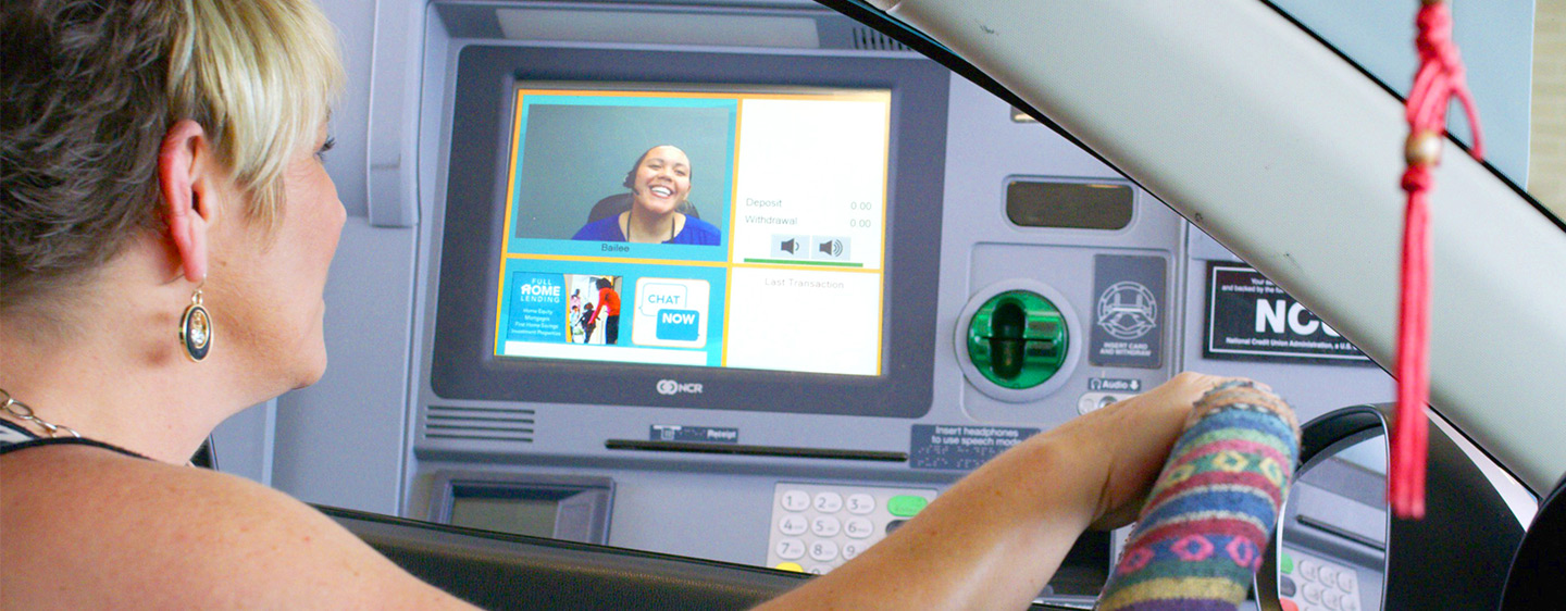 Member in the drive thru talking with a Live Video Teller.