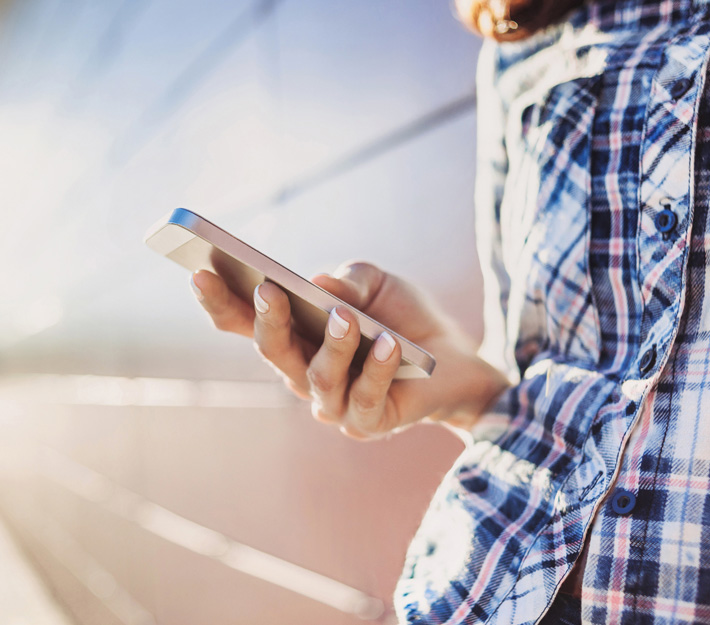 Side view of a hand holding a cellphone.