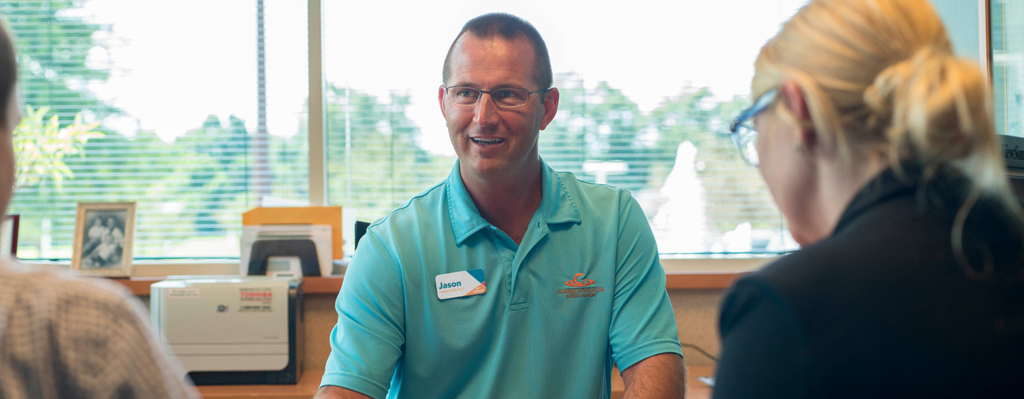 Employee chats with members.