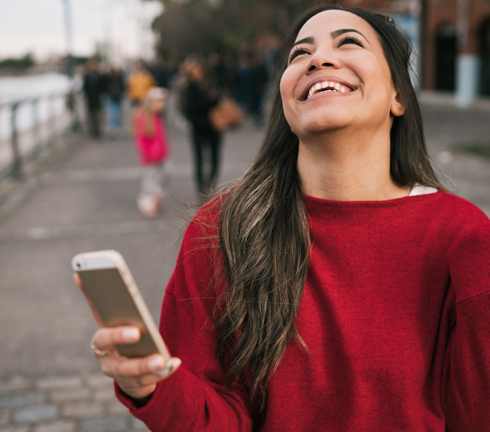 Girl with expression of success after reading something on her phone.