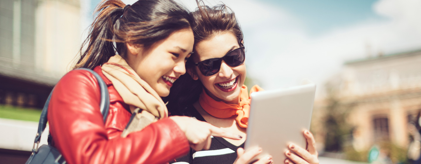 Friends use a tablet together.