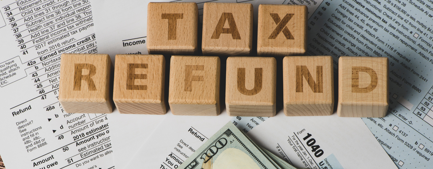 Tax refund spelled out in blocks with documents.