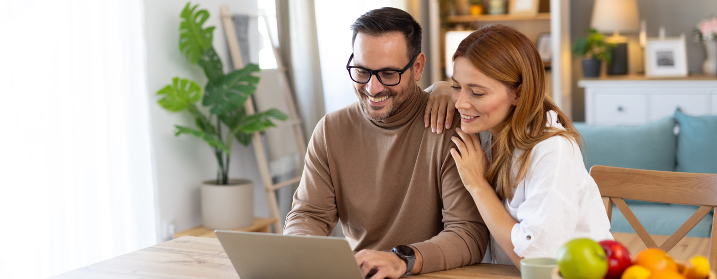 Image of a man and woman looking at a laptop together