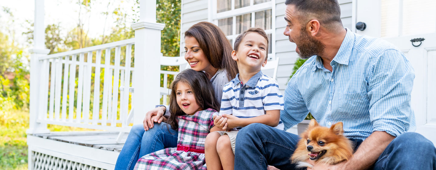 Photo of a family sitting together on their porch