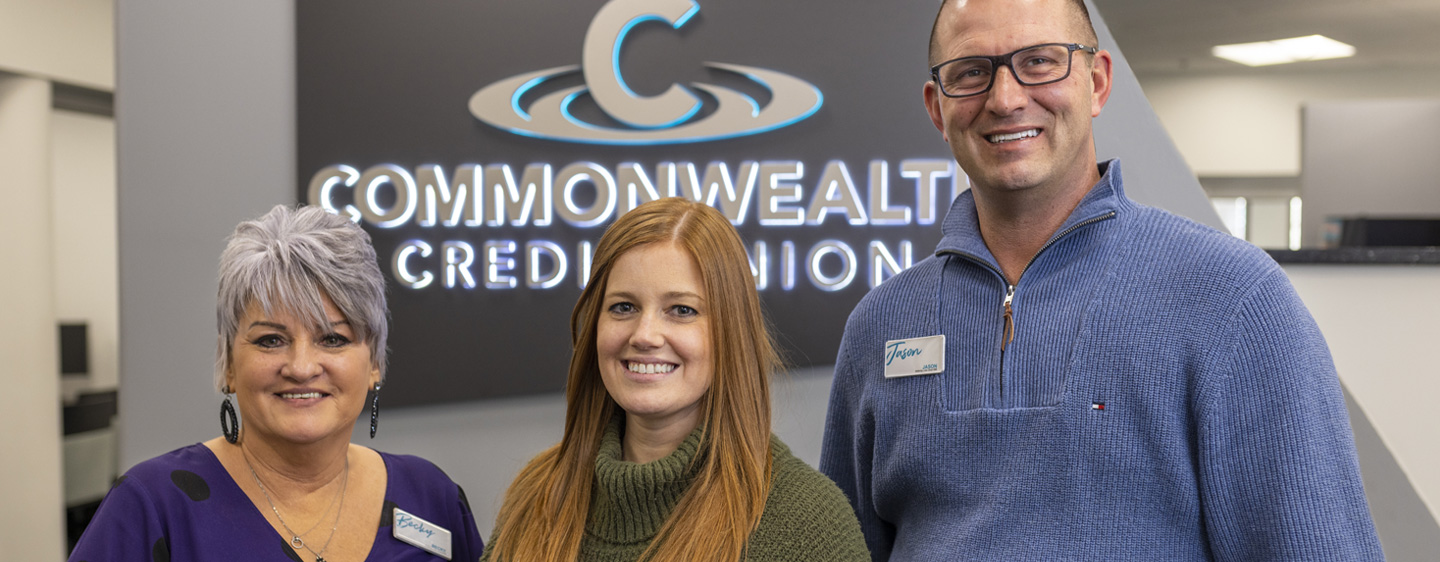 Image of 3 employees smiling at the camera.