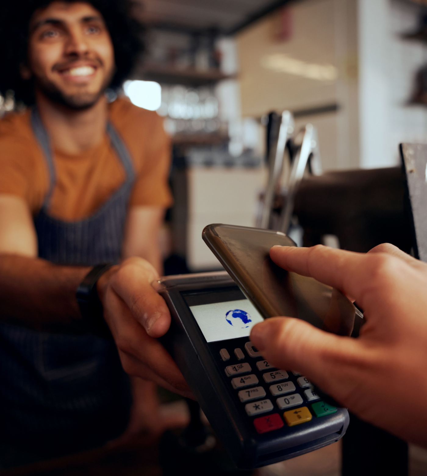 Image of someone using their phone to pay for a service