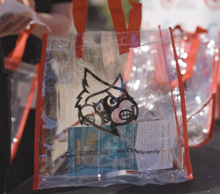 Photo of plastic tote bags with UofL/CCU logo on them