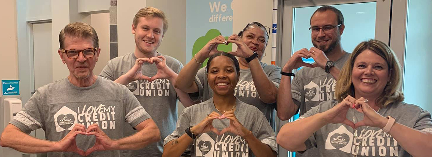 Commonwealth Credit Union employees making heart signs with their hands.