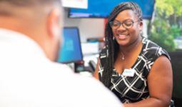 A CCU employee helps a customer.