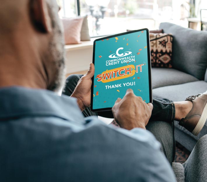 Man holds tablet, image depicts thank you Switch IT message from CCU