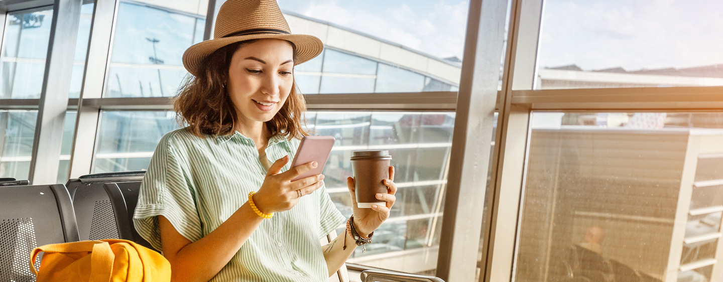 Woman waits for her flight at an airport.