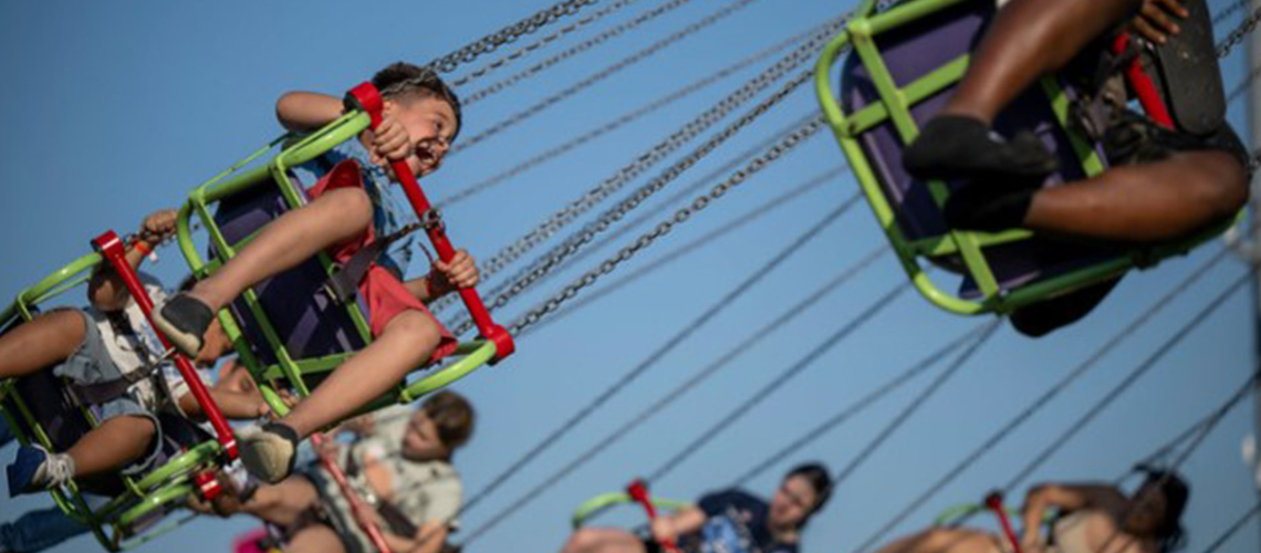 Kids on a swings ride at Kroger's Fest-A-Ville during the Kentucky Derby Festival.