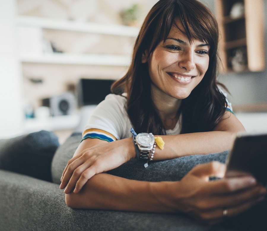 Woman smiling at cell phone