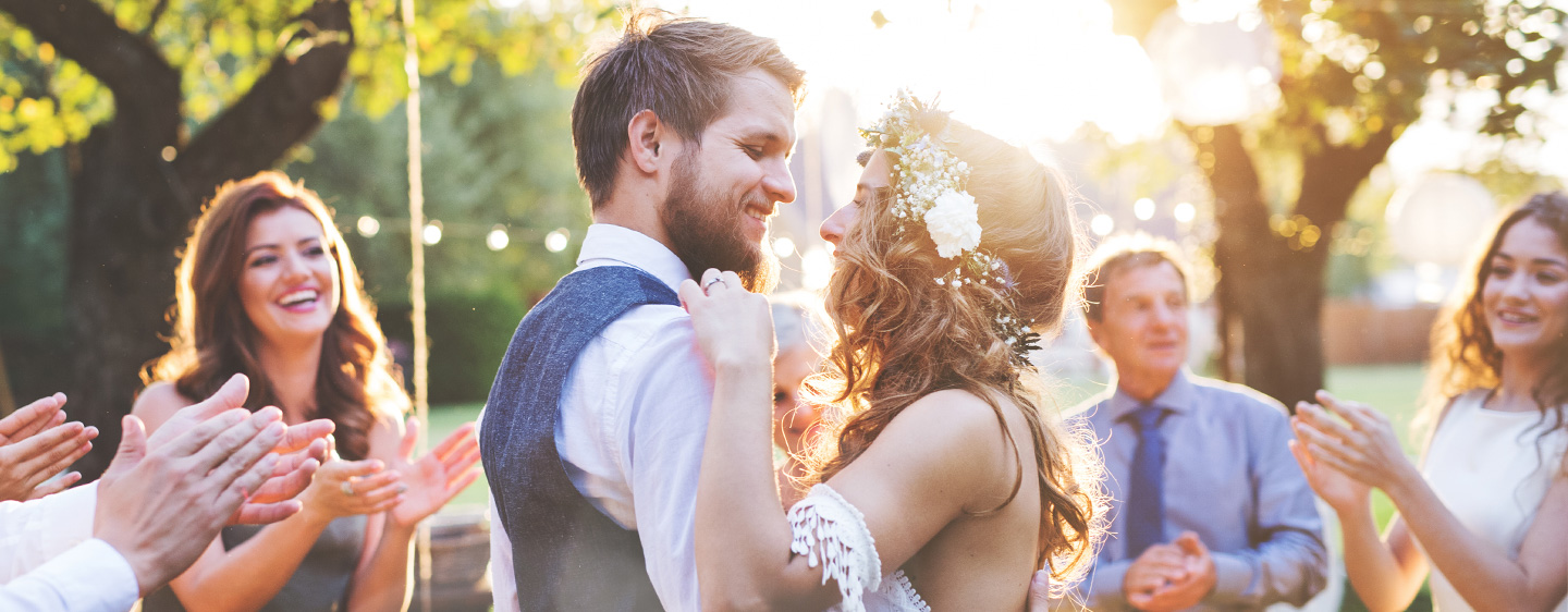 Bride and groom dancing at outdoor wedding.