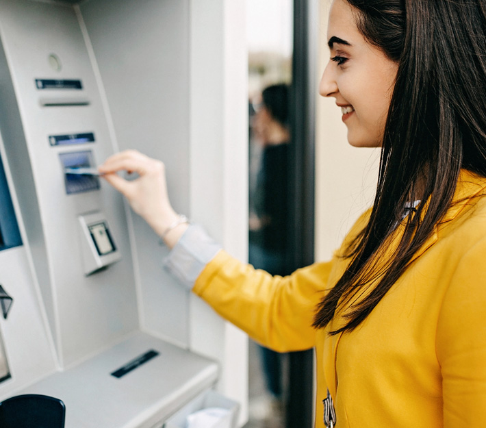 Woman uses an ATM.