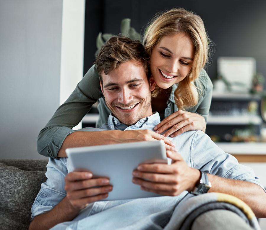 Woman and man smiling at ipad
