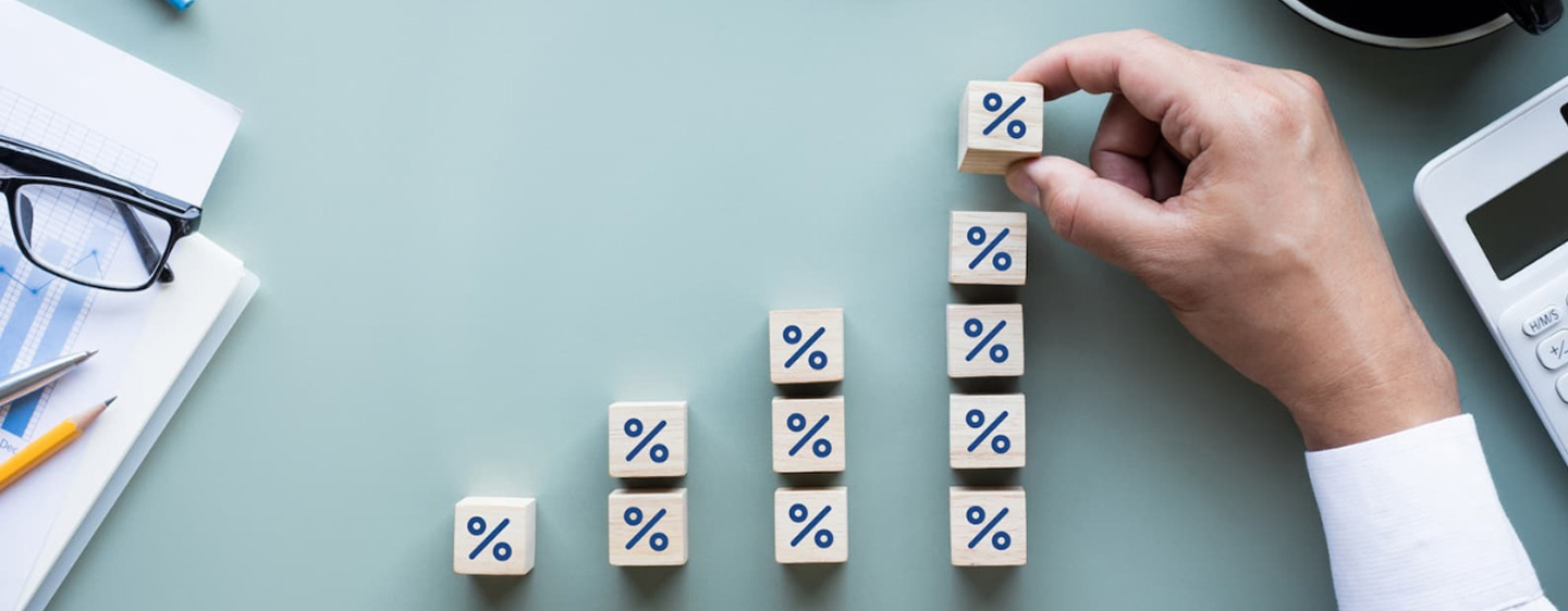 Image of a hand stacking percentage blocks