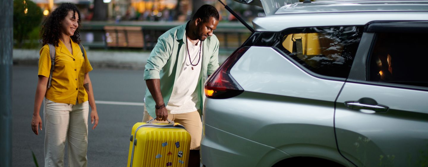 Pair taking rental car on trip.