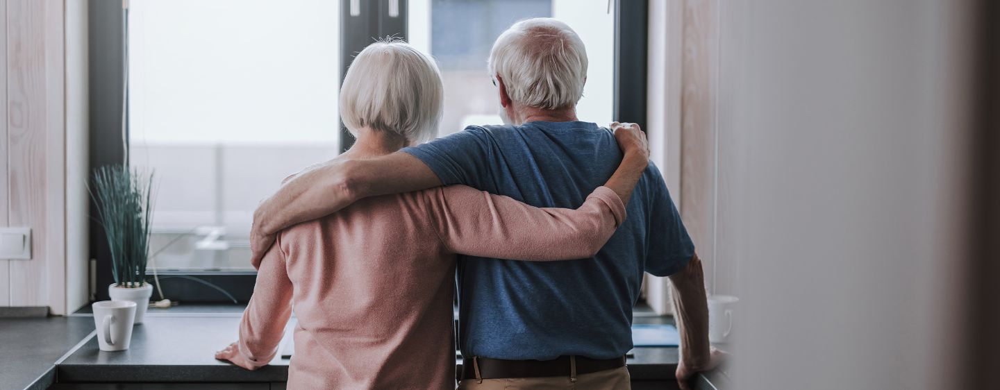 Elderly couple hugging. 