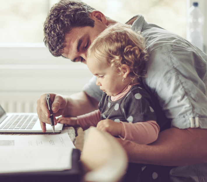 Father and daughter look over paperwork together.