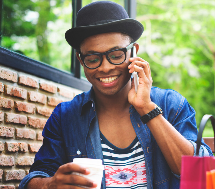 Man uses cellphone outside.