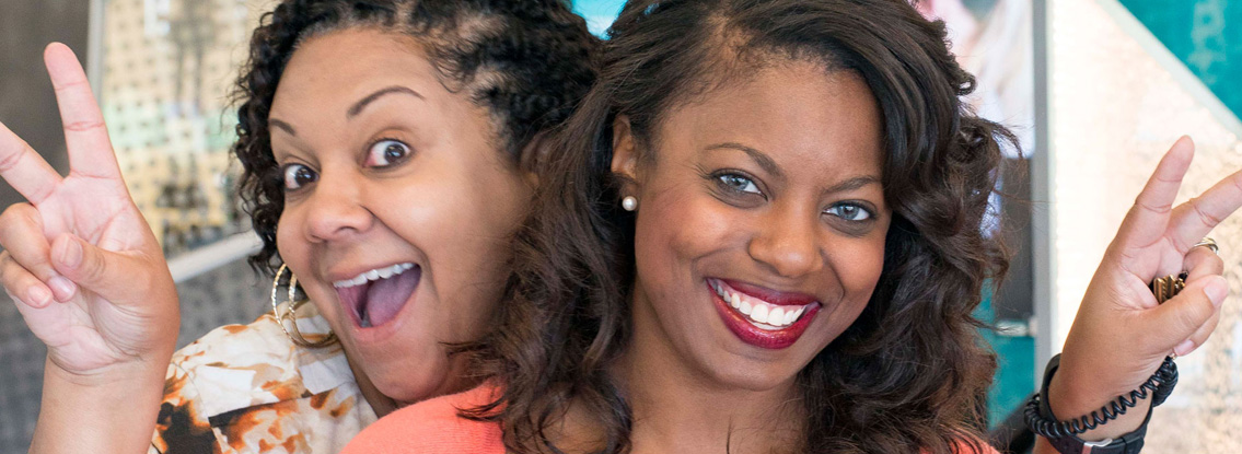 Two CCU employees smile and pose for the camera.