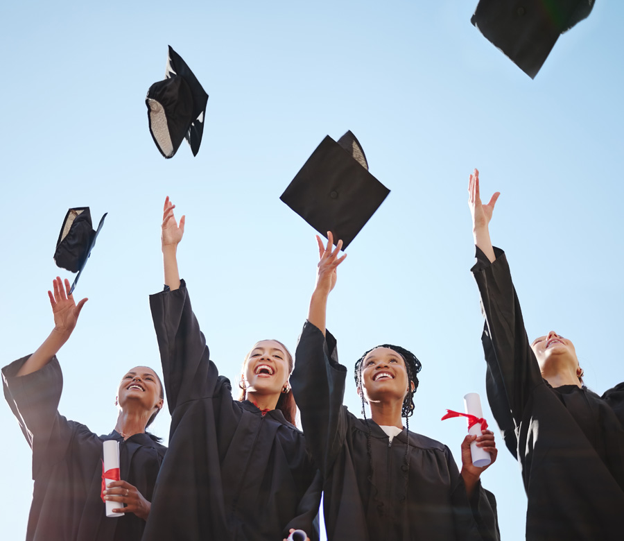 Graduates tossing their caps into the air.
