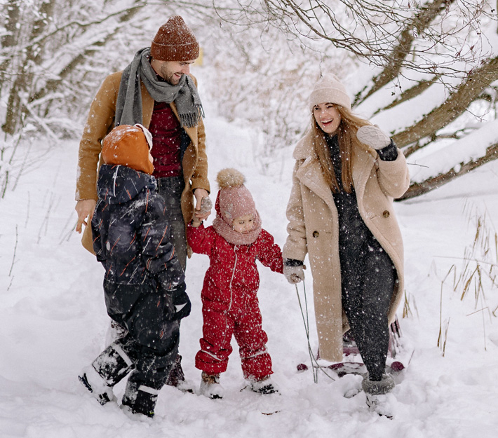 Family playing in snow together
