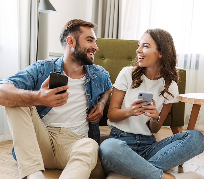 A couple, both on their phones.