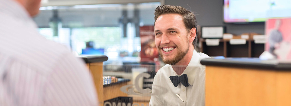CCU employee smiles at customer.