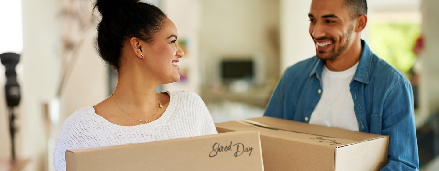 Image of man and woman holding boxes.