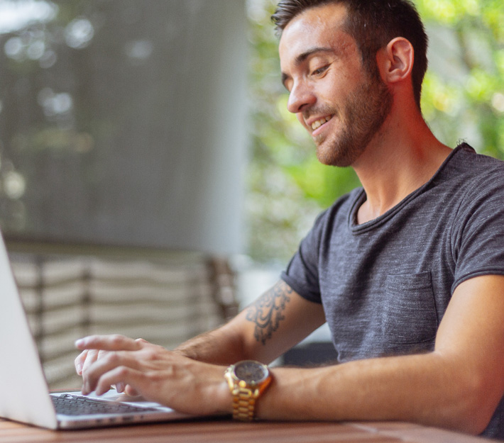 Man uses a laptop.