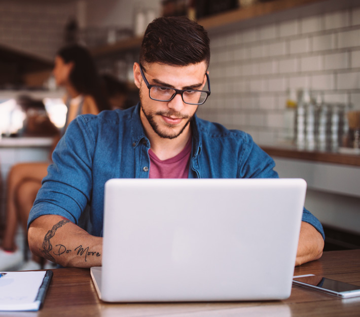 Man uses a laptop.