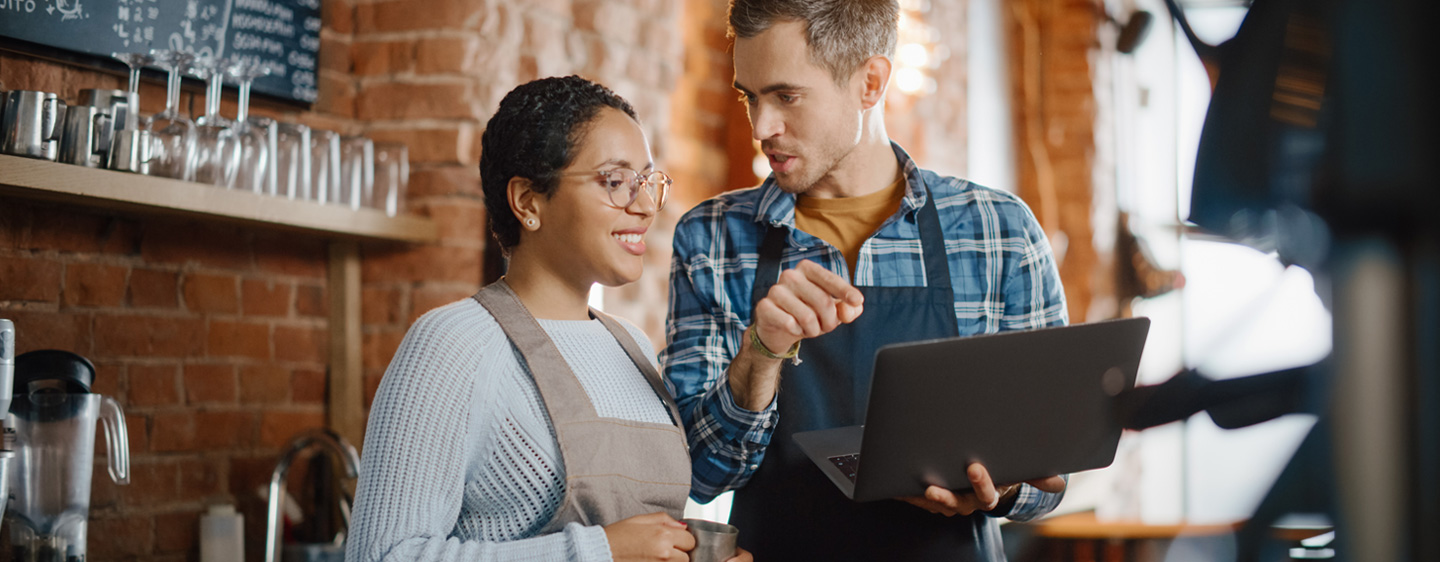 Image of man and woman who work in a coffee shop together for Kentucky Small Business Tax Credit Program page
